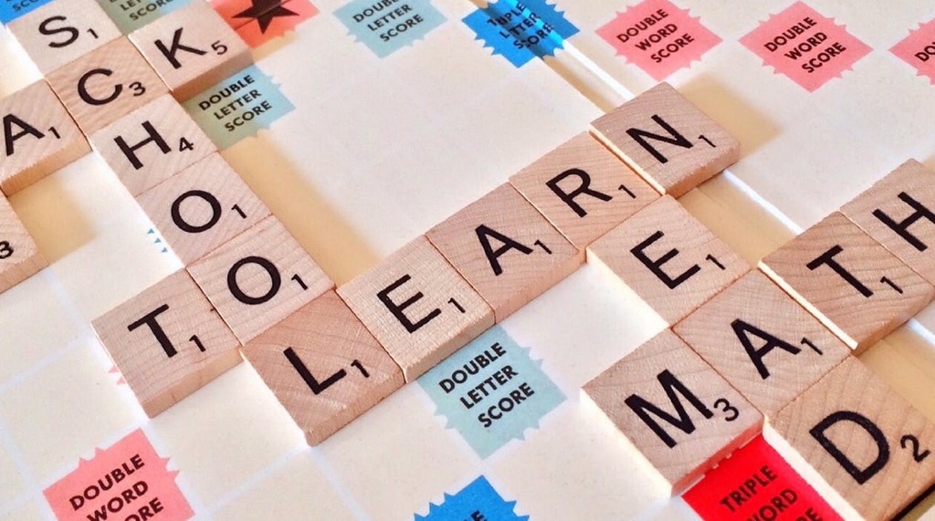 Scrabble tiles spell out Back to School, Learn, Math, and Read.